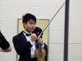 Senior Allen Zhang gives the rest of Chamber Orchestra a pep talk before they go out on stage. He urged them all to feel each emotion as they played, hoping that it would help them all to remember what they were trying to express. Photo by Sophia Comas