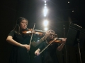 Sophomore Amy Joo and junior Audrey Parish play thier viola parts for String Quartet No. 8 on stage within the Century II theater in Wichita. They and the rest of Chamber performed for the KMEA conference where nine also played for the All-State orchestra. Photo by Sophia Comas