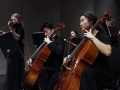 Seniors Joanna Park and Chris Chae play their cello parts onstage for their KMEA performance. The piece was meant to reflect the emotional angst of the composer, who contemplated suicide while writing it. Photo by Sophia Comas