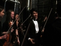 Senior Allen Zhang and sophomores Jenna Keeley and Aubrey Topham have a quick laugh backstage as they prepare themselves for the final moments before they perform. They and the rest of Chamber Orchestra came together to play String Quartet No. 8 for the Kansas Music Educators Assocition conference on Friday afternoon. Photo by Sophia Comas