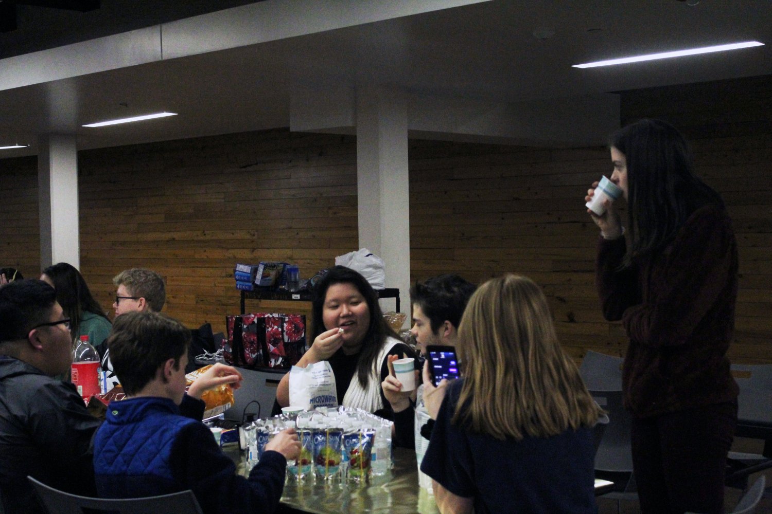 Senior Elizabeth Kim and StuCo club president Will Banister joke with eachother as they enjoy their food at the StuCo club feast.
Photo by Kyla Barnett