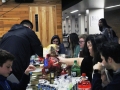 Freshman Neo Kim reaches for more food as he converses with friends at the StuCo club feast.
Photo by Kyla Barnett