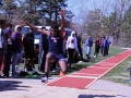 Joyful Jump. Freshman Talique Houston jumps for the long jump as Senior Parker Wilson takes a video and teammates watch the results. The meet took place in Bishop Stadium on Apr. 12. Photo by Mason Alberto.