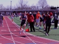 Words of Encouragement. Freshman Wyatt Henton runs his last lap in the 4x4 as Junior Aaron Hoff encourages him to catch up to the competition. Henton took second place after Topeka Heights on Apr. 12. Photo by Mason Alberto.