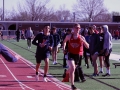 Speeding Up. Sophomore Jaylen Cruise runs his last lap in the 4x4 as his coach Kory Cool encourages him to keep his pace. Cruise tried to catch up but ended in second place on Apr. 12. Photo by Mason Alberto.