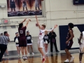 Mitch Munsen attempts to block a shot made by a Seaman High player.