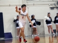 Peyton Weixelman points as a signal for his team while running down the court.
