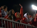 Seniors Mady McCollough and Madeline Crocker cheer in voctory after the MHS Indians scored the final point of the rivalry game against Junction City. The student section stayed loud and proud during the high-stakes game. Students like Crocker and McCollough bundled up and dressed in red to stay warm and school spirited. Photo by Hailey Eielrt