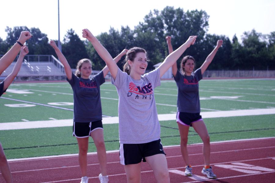 Freshman Sophia Travisano, freshman Bella Hager and junior 
Raegan Terrill practice poses for Hey Song