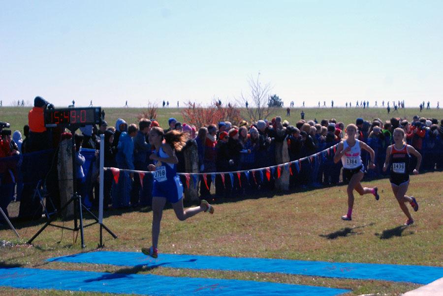 Senior Megan Ochoa crosses the finish line in her race. She took 16th overall with sophomore Cara Melgares taking 20th overall.