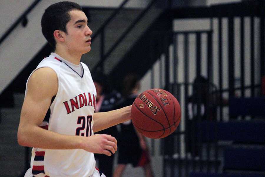 Senior Gabe Awbrey dribbles the ball up the floor in a game last season.