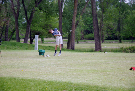 A Junior Varsity golfer drives the ball off of the number seven tee box at Stagg Hill