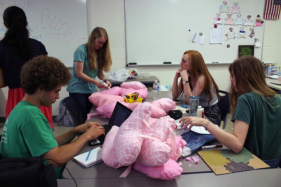 While Key Club president Rachel Chang conducts the meeting, secratary Josh Schwartz takes minutes while senior Caitlin Rusk continues to work on the pillows. Meanwhile, seniors Autumn Hattcliff and Shelby Baron listen. Beside creating pillows, the club also talked about the results of Peanut Days, where they made $448, and future fundraisers.