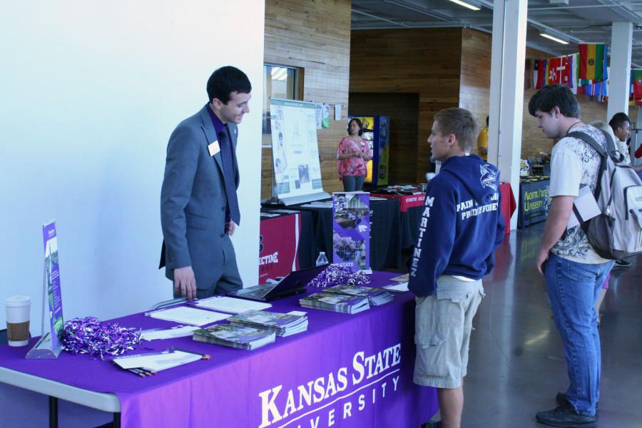 Senior Alejandro Martinez talks with the Kansas State University College representative Landon Leiker about appling to K-State during the College Fair, on Monday October 12.