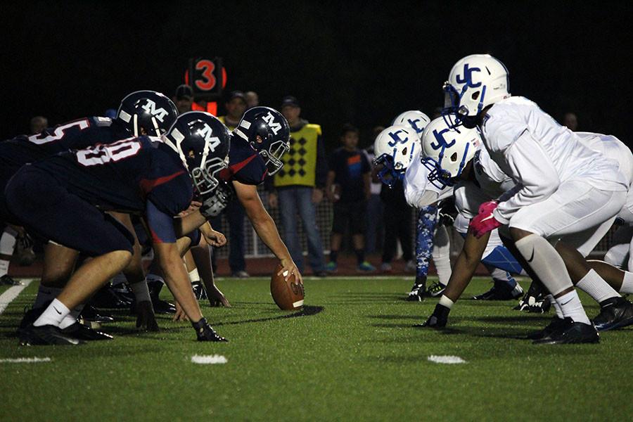 Manhattan Highs Varsity football team anchors down to go head to head aganist Junction City High School in the secodn quarter of the game on Friday, October 9th. Manhattan High lost in overtime with the score of 17-14.