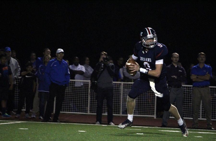 Junior Ian Trapp looks for an open receiver downfield Friday night. The Varsity football team lost in overtime against Junction City, on Friday, October 9th, 14-17.