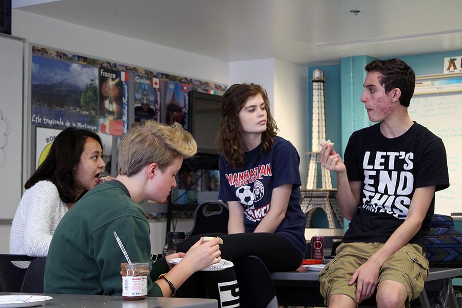 Snacking on bread, French Club officers Ashley Stuckwisch, Christine Martin and Isis Thornton-Saunders say goodbye to now-former president Isreal Wheatley. "I'm so glad we can do this," French Club advisor Kimberly Hoglund said during the gathering.