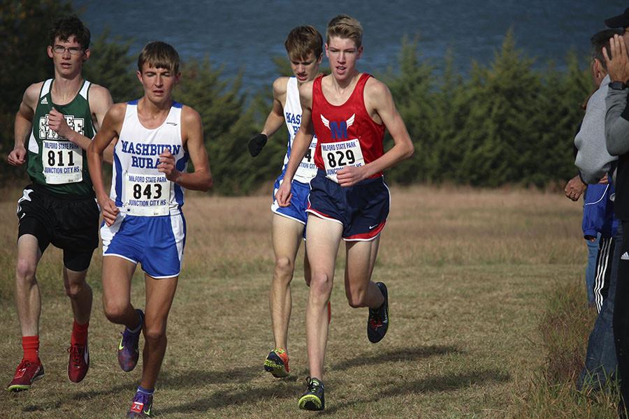 Junior Jackson Schroeder rounds the corner at cross country regonials, at Milford State Park. Schroeder came in first with the time of 15:42 on Saturday.