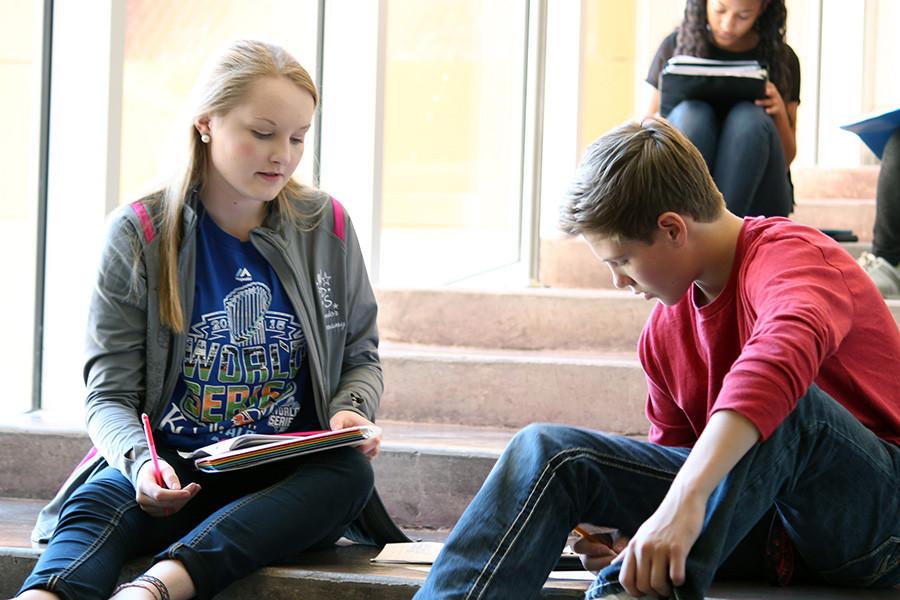 Working out a piecewise function, sophomores Ashlyn Gillispie and Chase Dillion work to earn cranberry sauce on the first floor bridge. Students in teacher Dedra Braxmeyers Advanced Algebra II classes were tasked with a scavenger hunt to find different Thanksgiving foods scattered throughout the commons, cafeteria and music hallways and were then required to correctly solve corresponding piecewise functions to earn each food item.