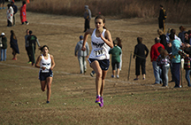 Senior Anna Keeley sprints to the finish line at Regionals. Keeley came in second with 19:16 at Regionals held at Milford State Park in Juction City, Kansas on October 23.