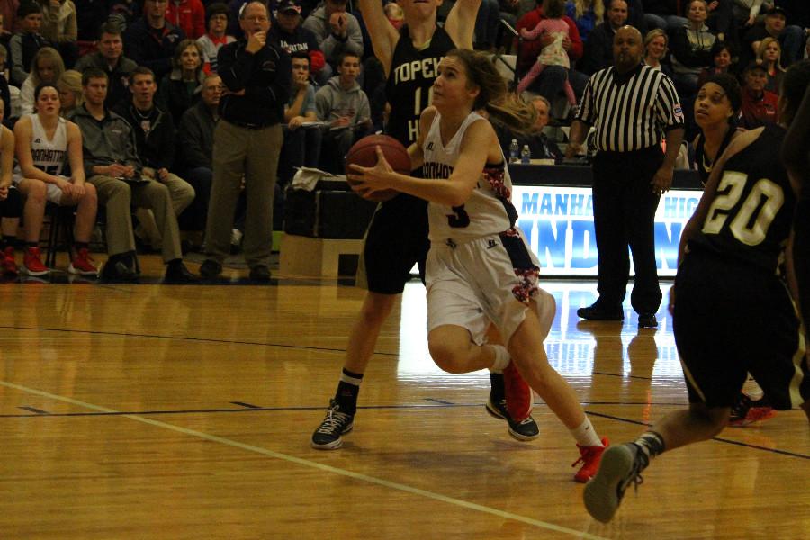 Junior Gigi McAtee drives to the basket Friday night against Topeka High. McAtee led the Lady Indians with 15 points in the win.