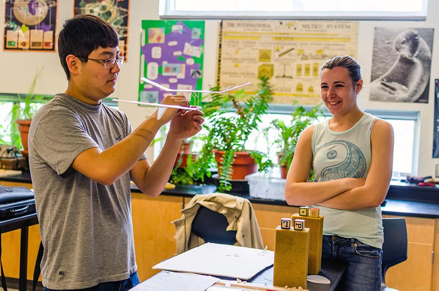 Senior Mackenzie Gwinner and junior Owen Li laugh as they work to perfect the airplane they hope will get them first at the Air Trajectory event at state.