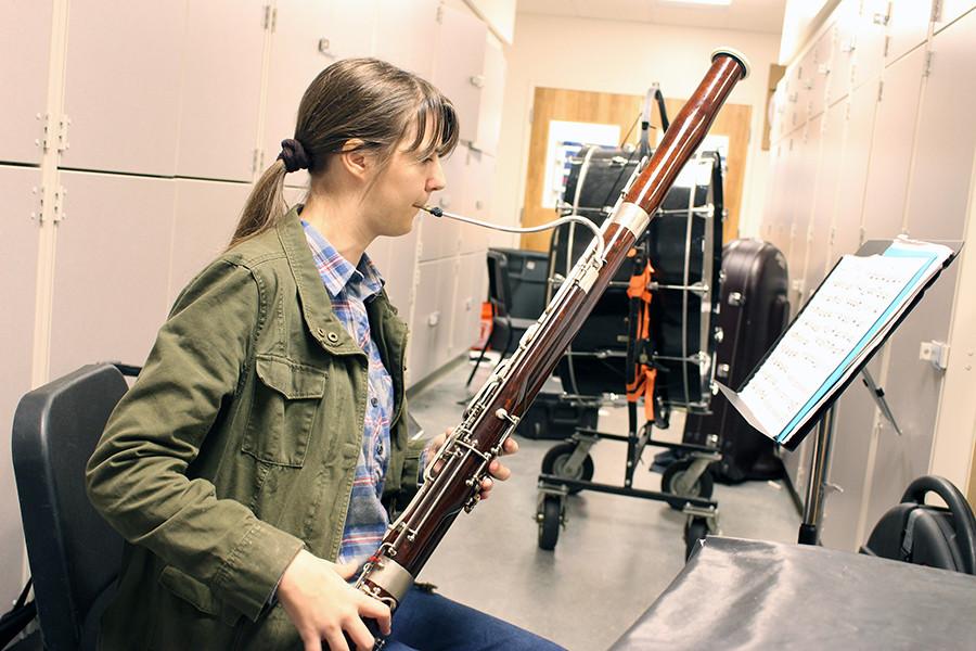During second hour Wind Ensemble, senior Erika Schneider(?) sits alone in a back practice room rehearsing Bourree I and II on her bassoon. Schneider also creates 2-D art and digital art.