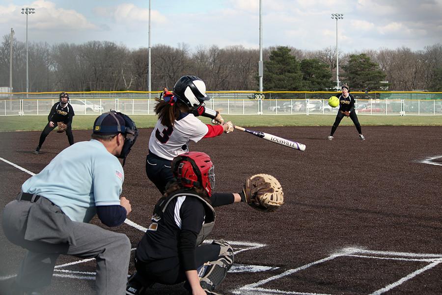 Freshman Haleigh Harper swings the for the ball at the opening game of the season for the Manhattan High Softball team, on April 1, 2016. The team won 8-3 in the first game of their double header against Topeka High School.