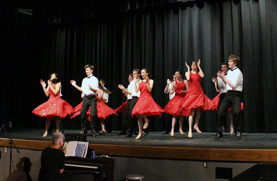 Mid-jump, Pops Choir performs at the annual showcase concert in Rezac Auditorium.