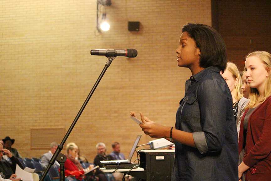 Junior Kathy Burton argues the side of removing the mascot at the public forum for the mascot debate. There are are two sides of the Manhattan High Stuco Organization that argued both points of the topic.