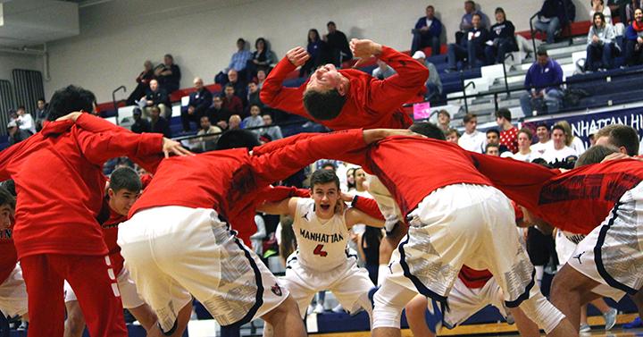 Without hype, game performance can decline. In an effort to excite the team, junior Nik Grubbs does a backflip in the middle of the team huddle. Before every game, all of the boys huddle together and chant as Grubbs flips. 
Photo by Angie Moss