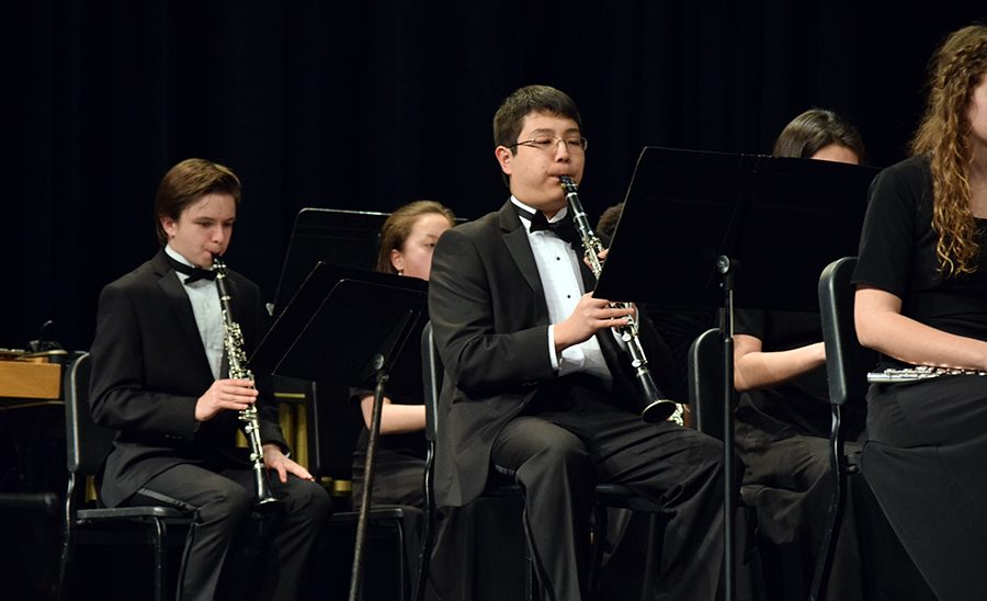 In the spotlight. Soloist, senior Owen Li performs Appalacihan Springs during the winter band concert on March 7.