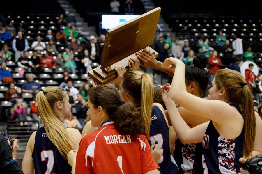 Raise the trophy. Manhattan High celebrates its 6A state championship. MHS beat Derby 44-42 in the championship game. It is the first title in program history.