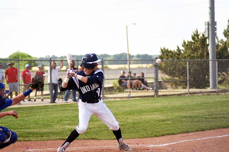 Swing for the fences. Senior Chance Henderson watches the ball cross the plate as he tries to hit it. Henderson scored two out of the four runs scored by the Indians.