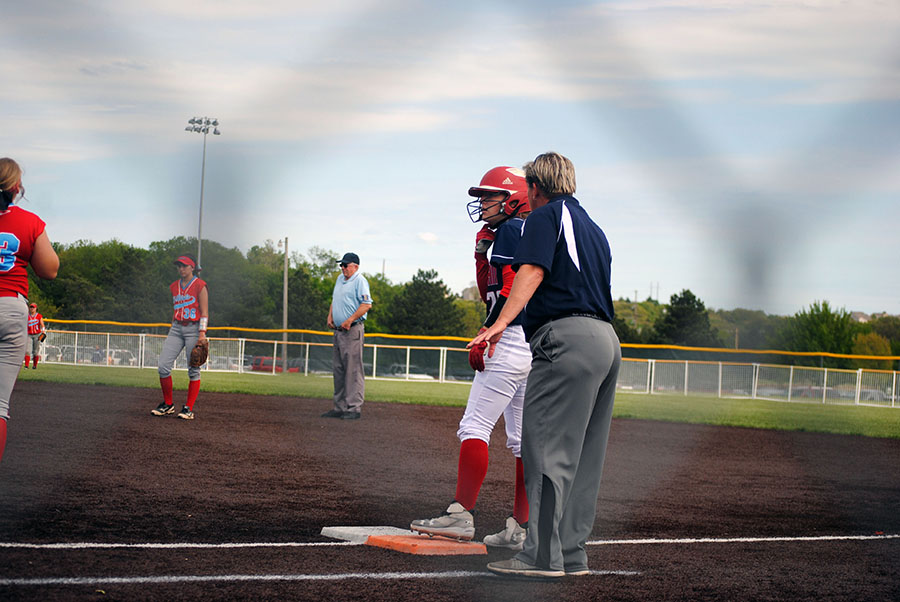 Assistant coach Connie Miller advises senior Chelsey Henry on how to stay safe. Manhattan would be swept by Shawnee Heights, losing 4-1 and 11-0.