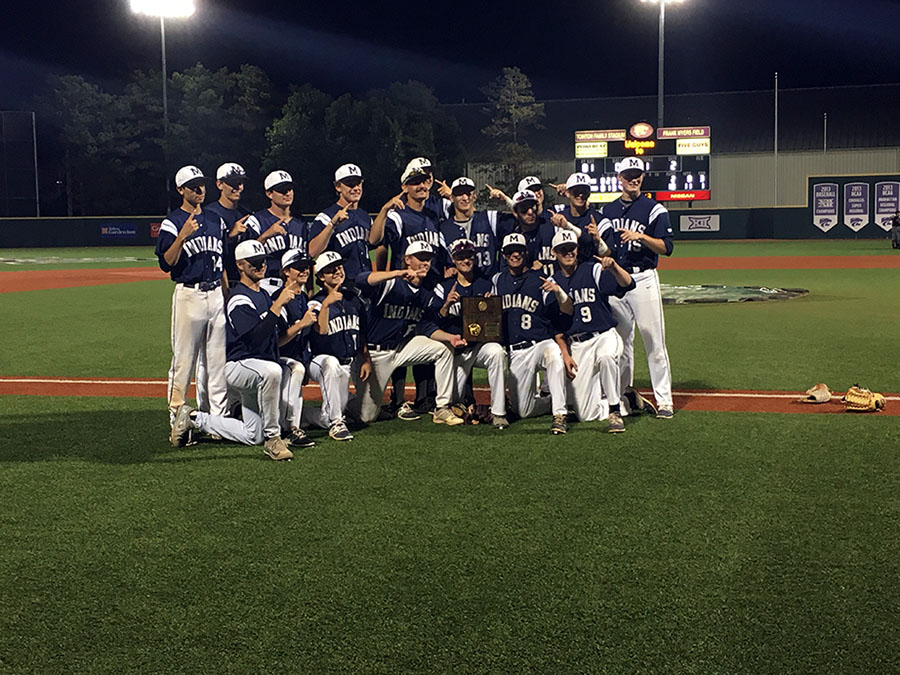 Manhattan High poses with the regional championship trophy after beating Lawrence High 10-2.