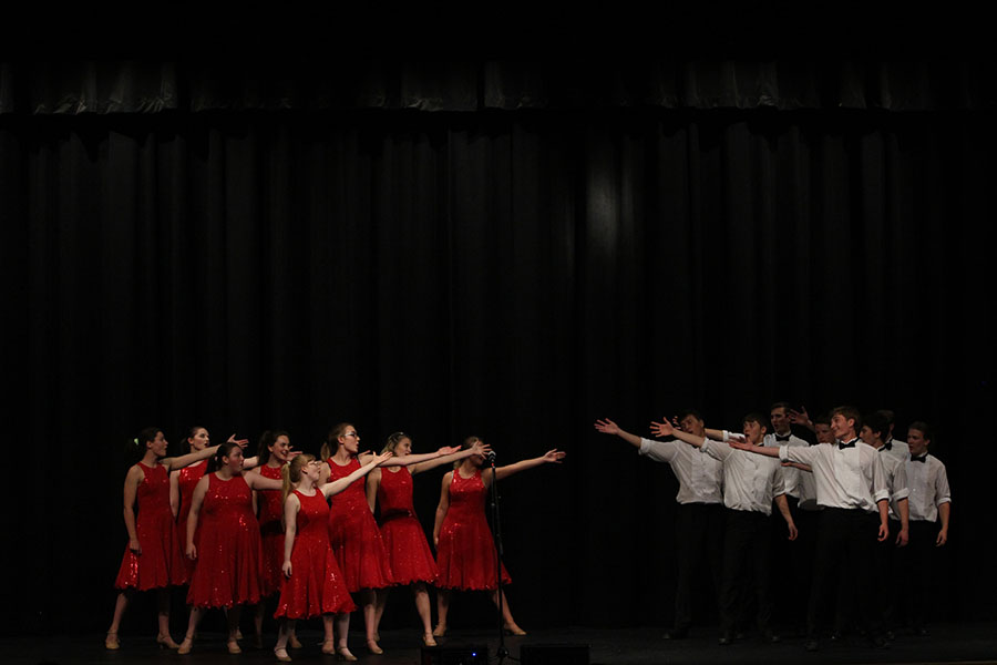 The boys and girls of Pops Choir separate and reach out towards each other during their "Grease" performance.