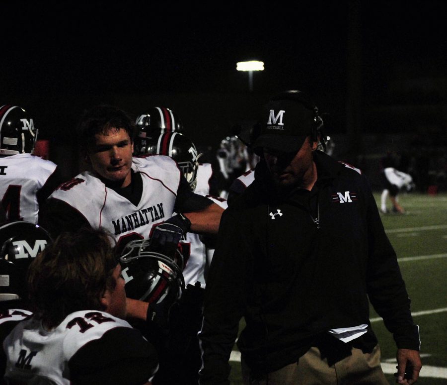 Head coach Joe Schartz communicates with senior lineman Conner Lierz during the Blue Valley Northwest game. Schartzs future with the program is in question after a hazing incident occured on Oct. 25 involving members of the football team. 