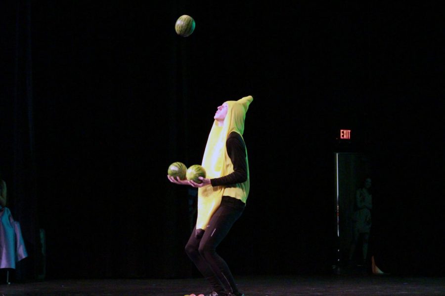 Senior Logan Logback awaits his falling melon and prepares to toss the next one in the air to continue his juggling routine. Logback dressed in costumes for his talent while juggling odd items.