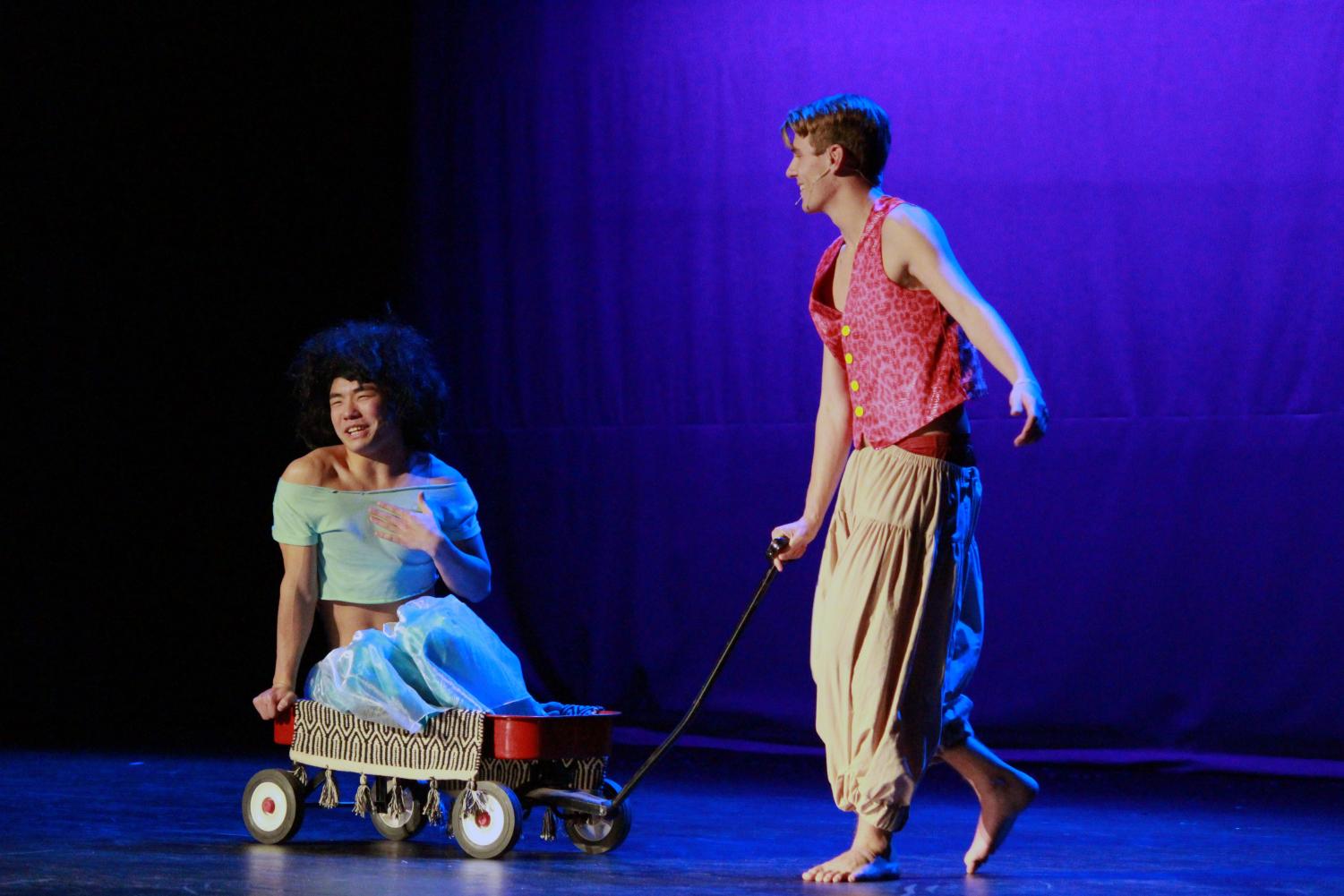 Junior Suman Wang rides on the 'magic carpet' helping senior Will Erickson with his performance of the beloved Disney movie