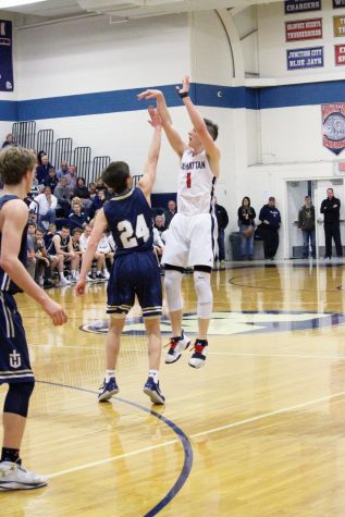 Senior John Ostermann rises up for a three point shot over a Hayden defender. Ostermann had 7 points on the night all coming in the first half.