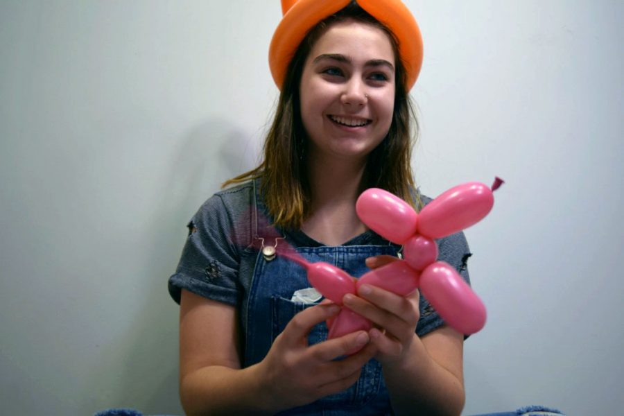 Freshman+Hailey+Eilert+practices+tying+balloons+into+dogs+and+various+animals+in+her+free+time.+Although+balloon+tying+may+not+be+a+fine+art+class+offered+at+Manhattan+High+School%2C+classes+that+are+fine+art+promote+the+individuality+of+students+and+encourage+them+to+try+new+things.+%E2%80%9CBalloon+animals+are+a+cool+way+to+bring+joy+to+others%2C%E2%80%9D+Eilert+said.+It%E2%80%99s+really+fun+to+see+someone%E2%80%99s+face+light+up+when+I+give+them+an+animal.%E2%80%9D+Photo+by+Makenna+Eilert