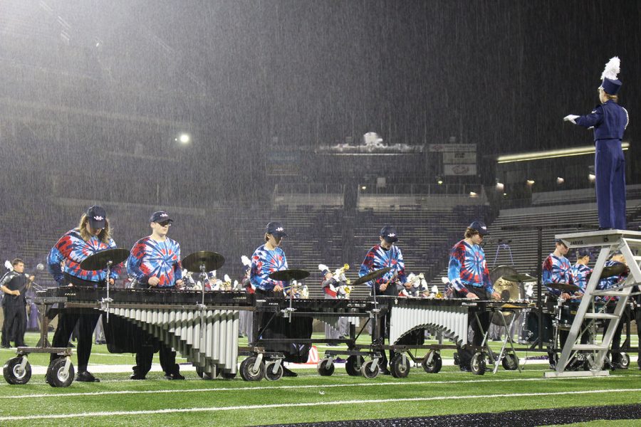 Members of the pit perform in the rain during the band festival. The Manhattan High School Big Blue Marching Band participated in the annual band festival, there, they were judged and awarded a score for their performance. 