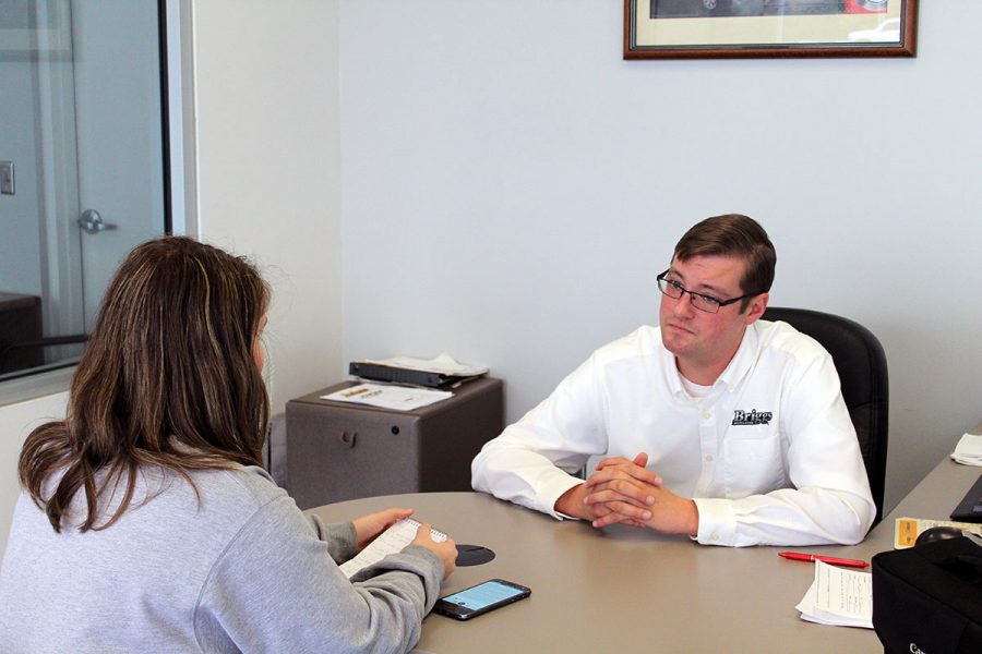 Heger, a Manhattan High junior, interviews Briggs sales representative John Windham. The interview covered the car buying process and finances. 