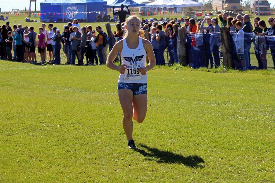 Senior Clara Mayfield sprints to the finish line at the Cross Country State competition. Both the Girls and Boys Manhattan High School Varsity Cross Country teams competed on Oct. 27, at the meet Mayfield placed third. 