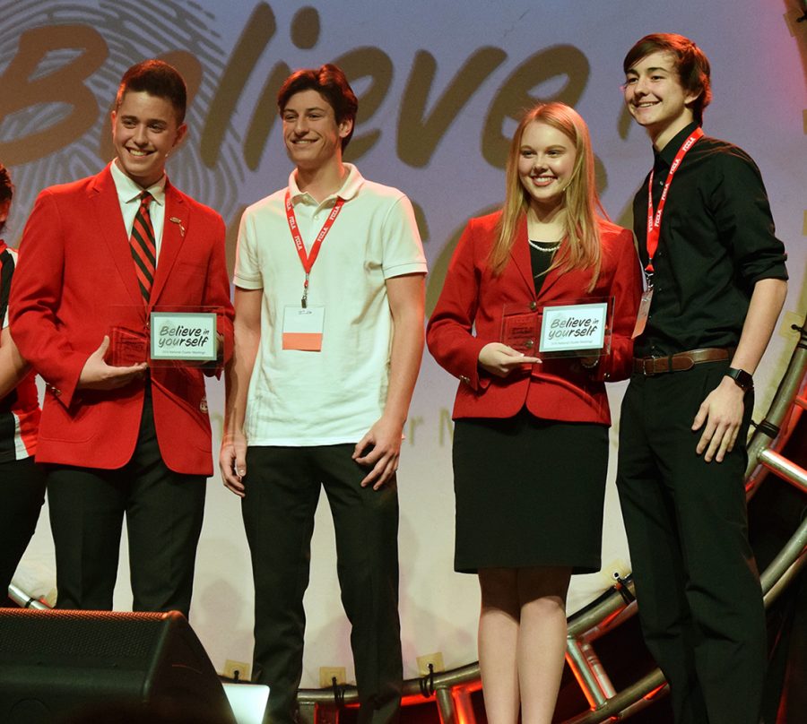 Seniors Noah Applegren and Mason Jackson pose with two FCCLA national officers during the awards ceramony at the FCCLA national cluster meeting. Five Manhattan High School FCCLA members traveled to Louisville Kentucky on Thursday for the national cluster conferece, at cluster all five students competed in skill demonstration events. Applegren placed second and Jackson plcaed first in the occupational level culinary knife skills competition.