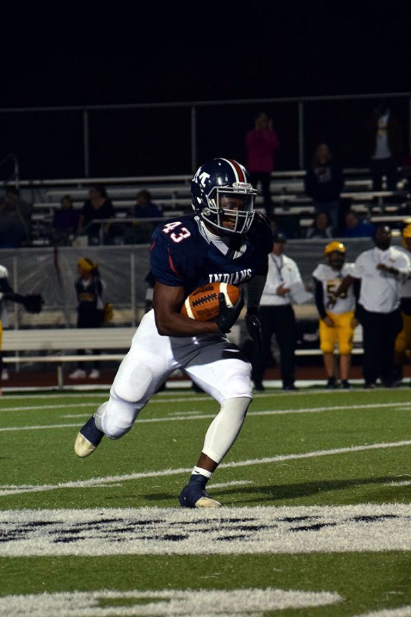 Senior Javon Peoples runs with the ball down the field at the Manhattan High School Varsity football game against Wichita Southeast. Peoples is normally sporting the number 6 jersey but due to his jersey ripping prior to the game, Peoples wore number 43 at the game. The Manhattan Indians beat Wichita Southeast 73-20. 