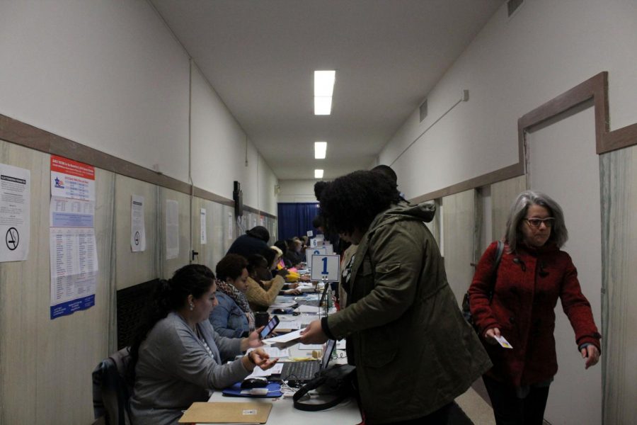 Chicago residents fill out registration forms before voting for the United States House of Representatives and for the U.S. Senate.