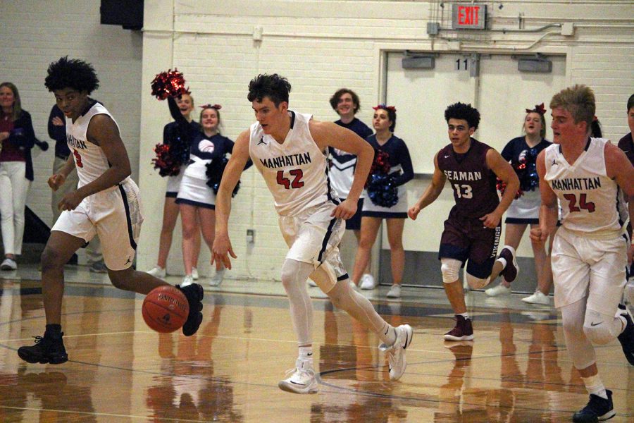 Junior Chandler Marks moves down the court during the varsity basketball game on Dec. 8. The home game ended wiht a one-point difference, but the Indians took the win over the Seaman Vikings, 49-48.