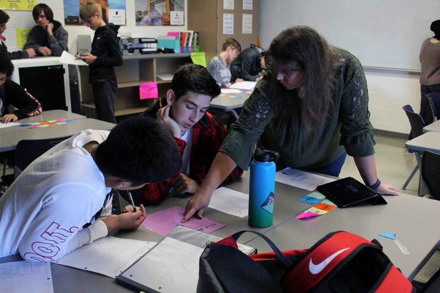 Jancy Radke points something out to Sophmores Julian Avila-Vargas and Easton Roberts during Geometry class. The class spent the period participating in an activity that combined math with the classic game Who Dunnit. It was fun and it was a good review, Roberts said. 